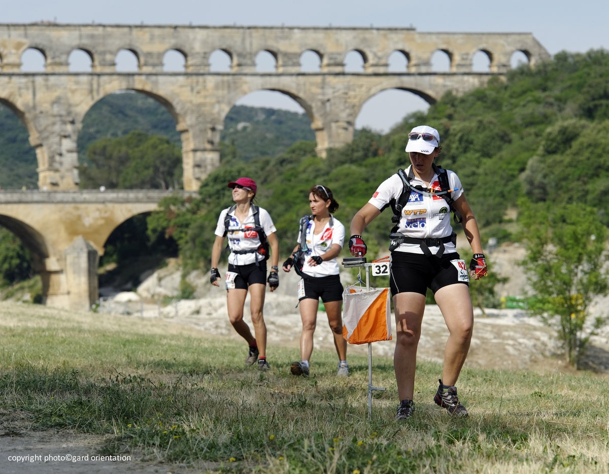 Photo de personnes qui courent avec le Pont du Gard en arrière-plan